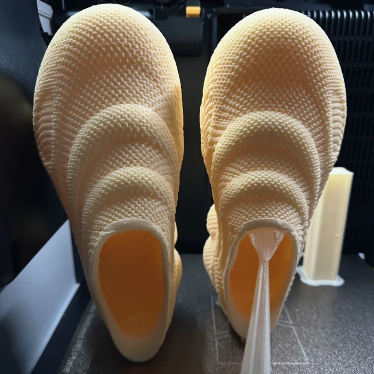 Freshly FDM 3D printed mesh structure shoe prototype with undissolved PVA water-soluble support material, demonstrating temporary support for complex hollow lattice structures
