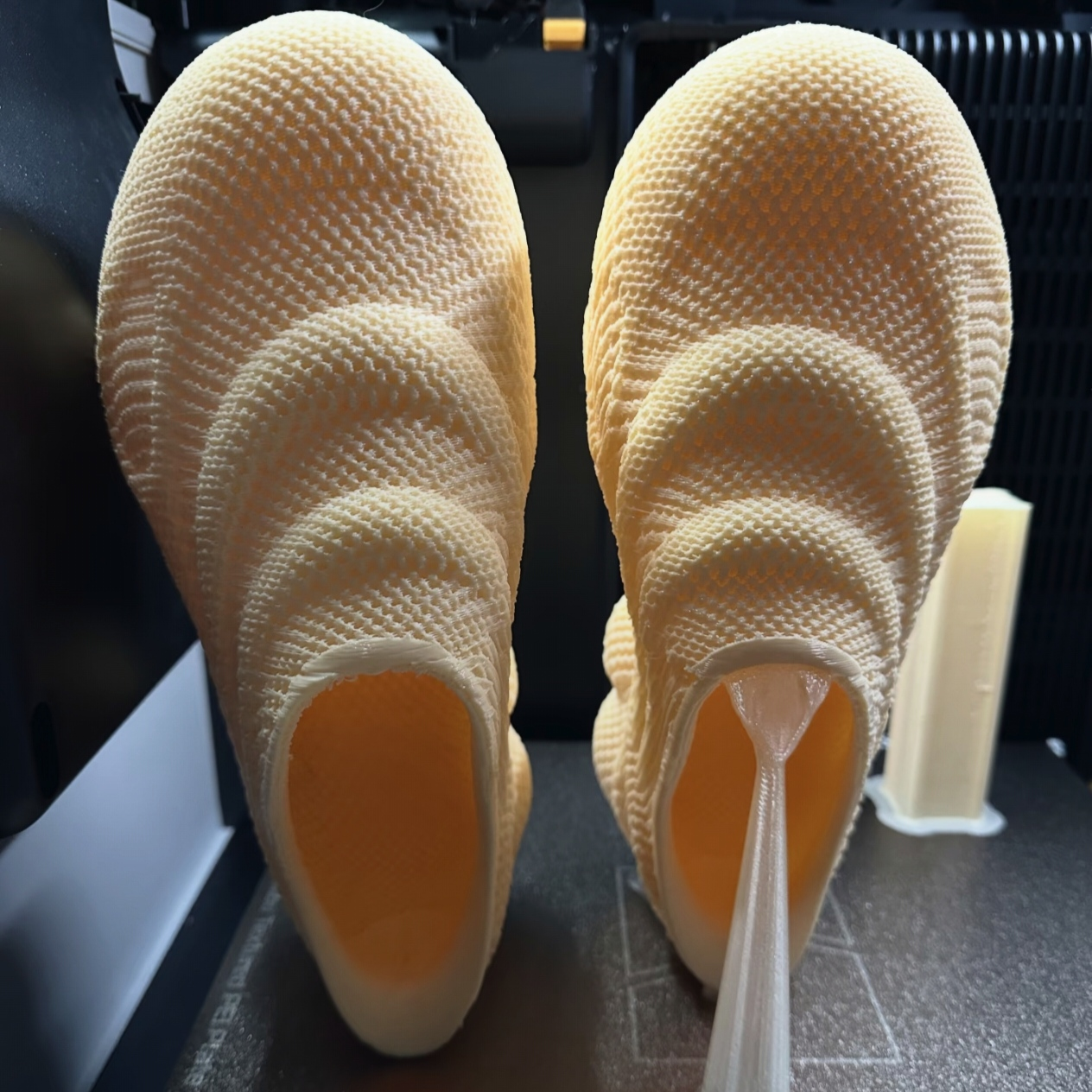Freshly FDM 3D printed mesh structure shoe prototype with undissolved PVA water-soluble support material, demonstrating temporary support for complex hollow lattice structures